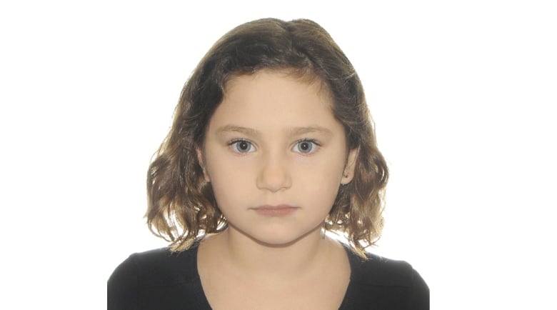 A profile photo of 7 year old Maria, the victim of a deadly hit and run in Montreal. She has light brown hair, blue eyes, is not smiling and has a black top on. 