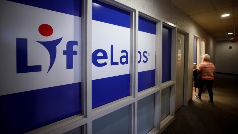 A dark hallway with a giant LifeLabs sign running nearly its entire length.