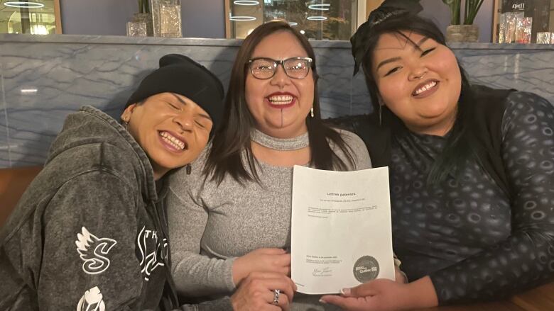 Scott Wabano, Geraldine Shecapio and Jomarie Einish pose with official document recognizing Two Spirits of Eeyou Istchee as non-profit organization.