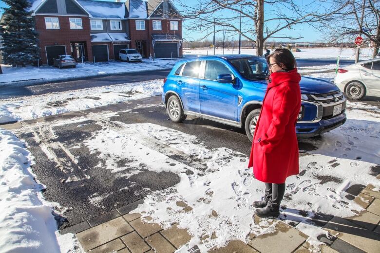 Christine Taylor stands in the driveway of her Findlay Creek, Ottawa home.