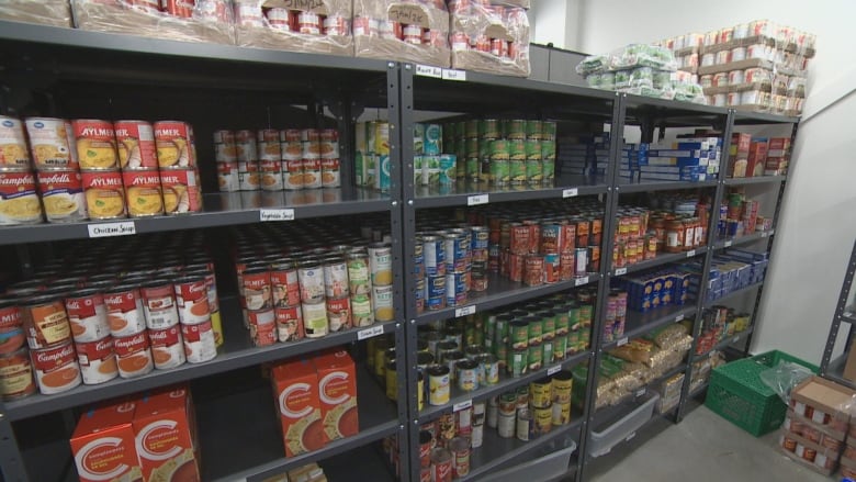 Cans of food on a food shelf at a food bank.