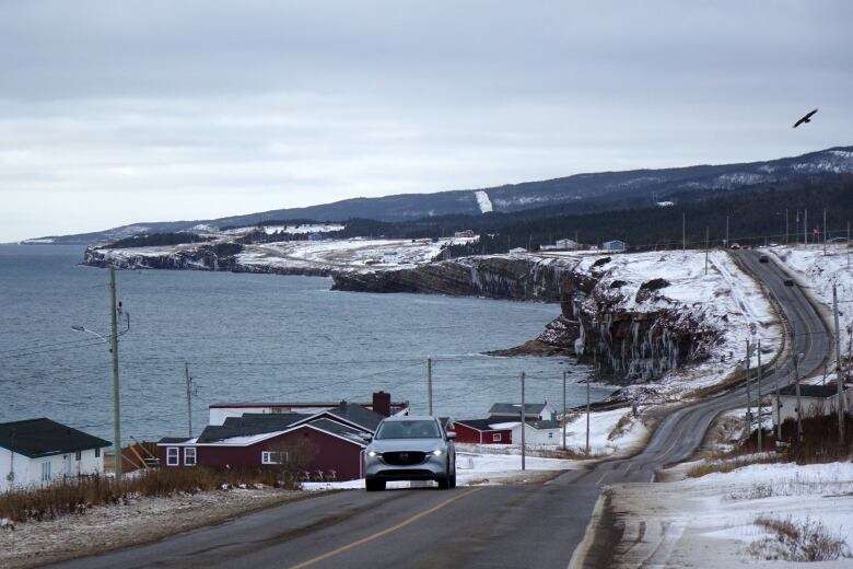 An SUV drives up the main road in Campbell's Creek.