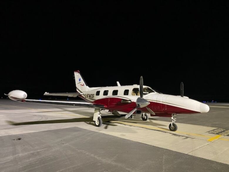 A small propeller plane on a tarmac