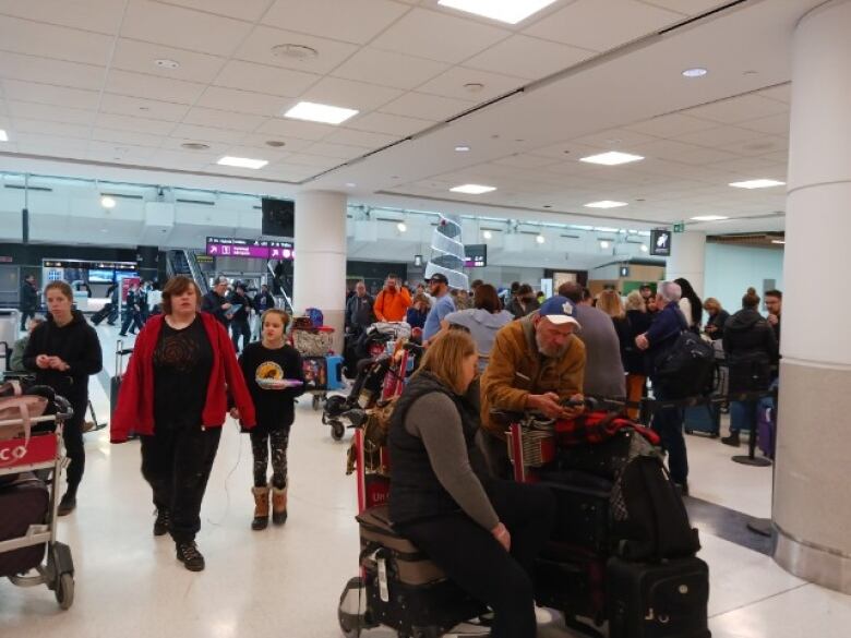 Travellers move through Pearson International Airport.