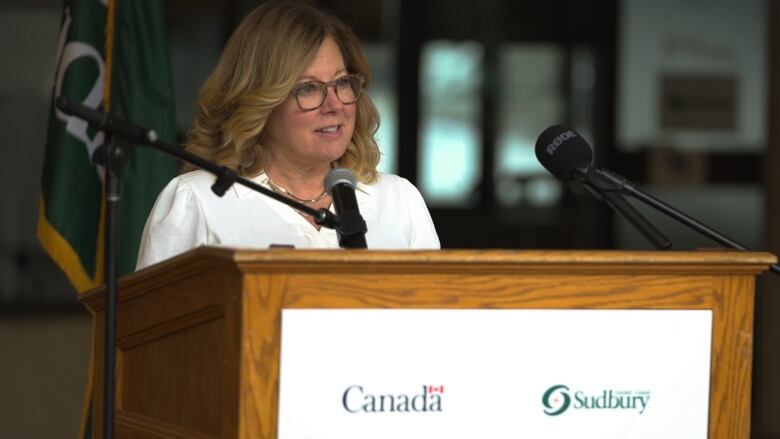 A woman standing at a podium.