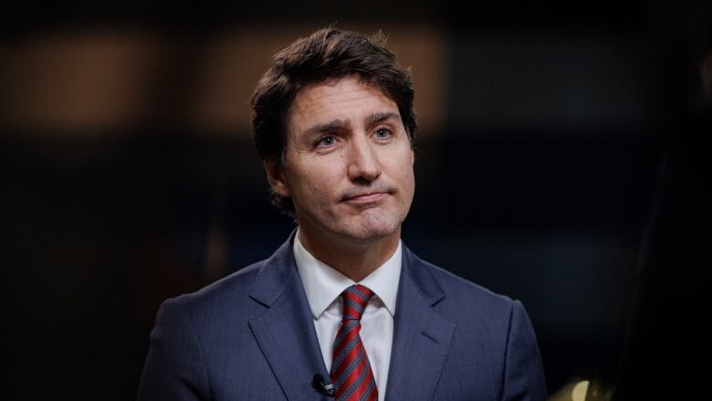 Justin Trudeau listens to a question during an interview.