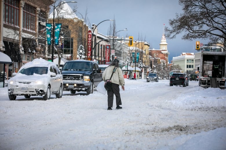 A person walks down the street in Victoria, B.C.