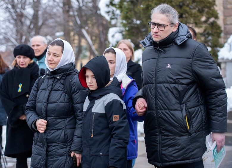 Parents Galyna (left) and Andrii Legenkovska (right) and siblings look on as her casket is taken from the church following her funeral in Montreal, Wednesday, December 21, 2022. 