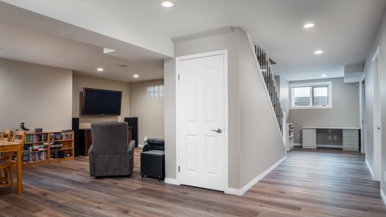 A basement suite in Calgary with a staircase and a living room area. 