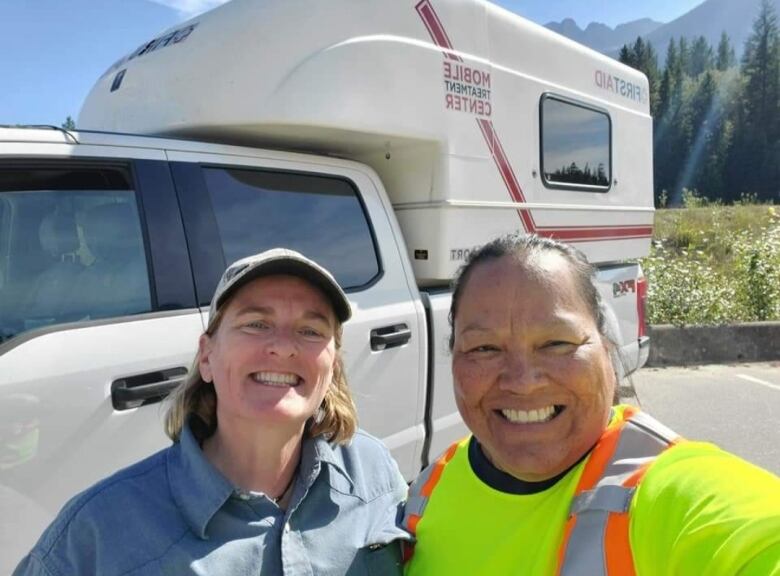 Two medics working stand side by side. Rhonda Ned is at right.