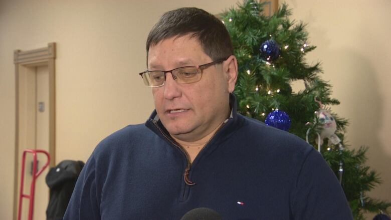 Mark Arcand standing in front of a Christmas tree