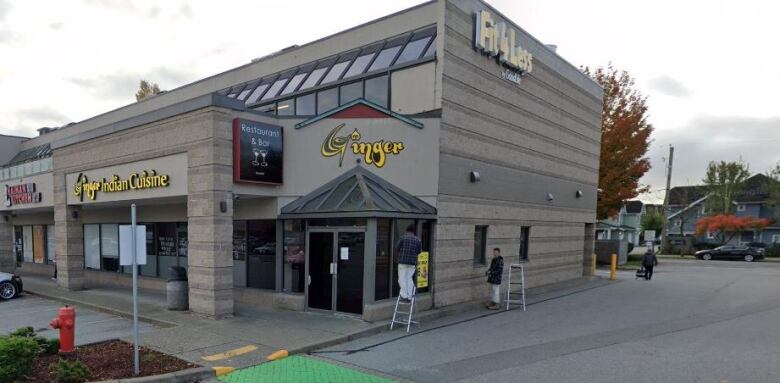 A squat brown building in a strip mall reads 'Ginger Indian Cuisine'. A smaller sign reads 'Restaurant and bar'.