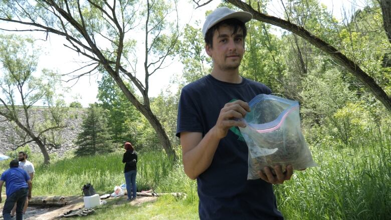 Brendon Samuels stands with a bag of discarded fishing lines collected from a cleanup earlier this year