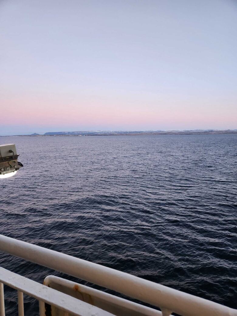 Water with a city in the background. 