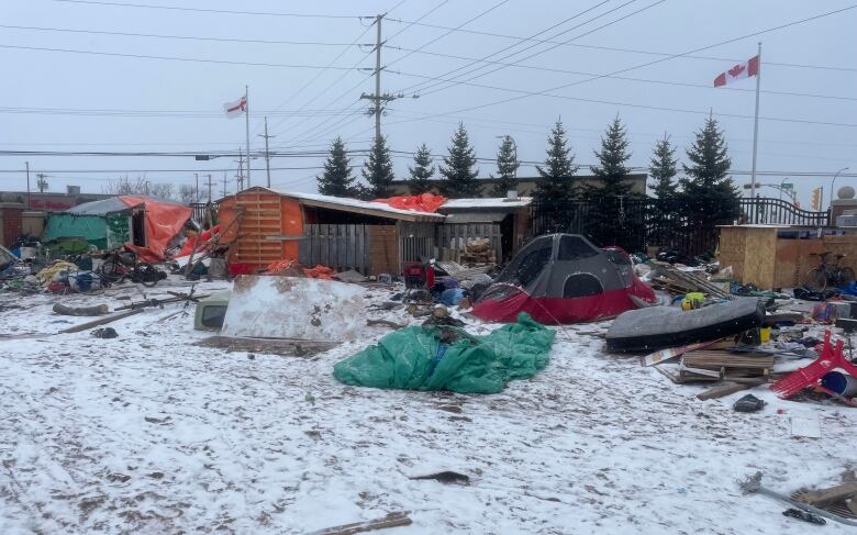 Wooden structures and tarps at the encampment in Charlottetown.