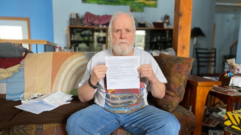 Man holds letter from City of Ottawa