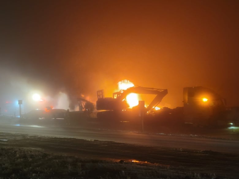 Flames appear behind vehicles involved in a large multi-car collision north of Airdrie, Tuesday evening.