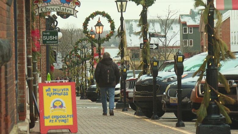 A man walks down the sidewalk on Queen Street in Charlottetown.