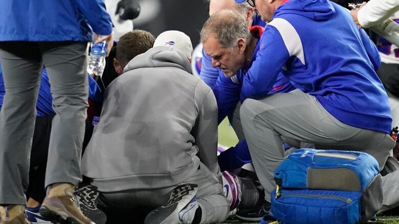 Medical personnel examine an NFL player after an injury he sustained.