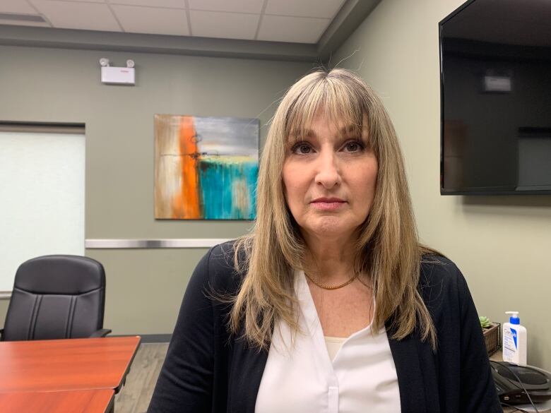 Woman stands in a board room