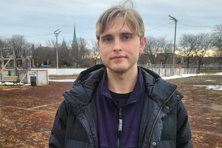 man standing in front of ice rink with no ice