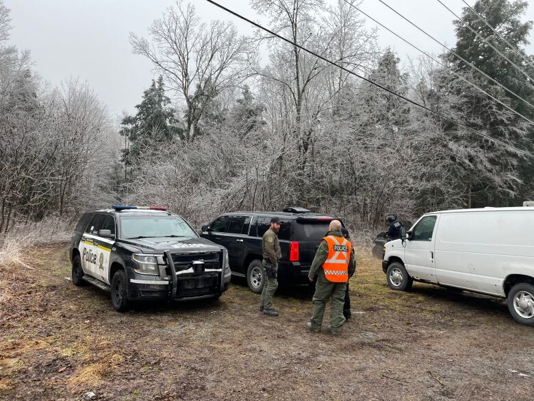 Police cars in a field.