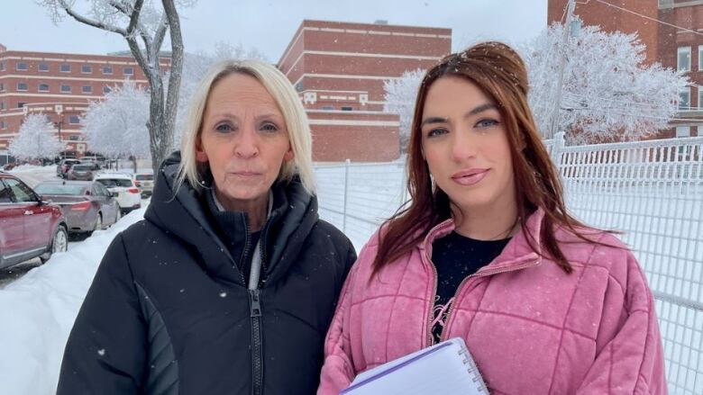 Mother and daughter pose for a picture in front of the Regina General Hospital.