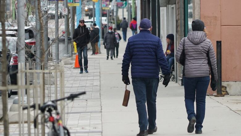 Random Winter photos around downtown Ottawa. Bank Street, Laurier St, DND, MacKenzie King, Shaw Centre, Rideau Canal, City Hall, Sparks Street.               See people walking on pedestrian only street, presumably Sparks Street and section of lit xmas tree in fg.