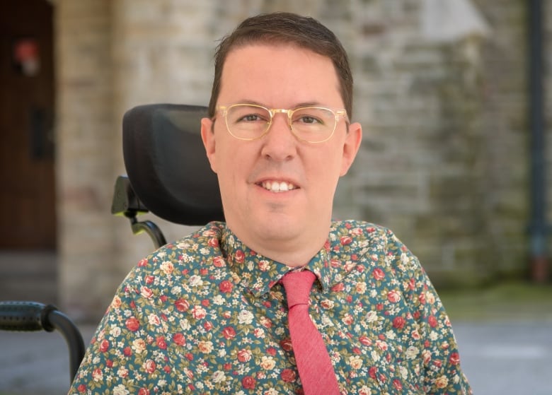 man with glasses in floral shirt