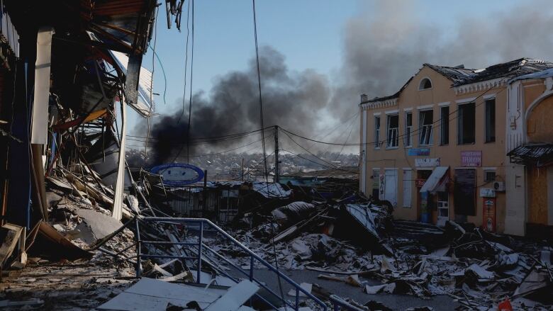 Smoke rises from a destroyed building.