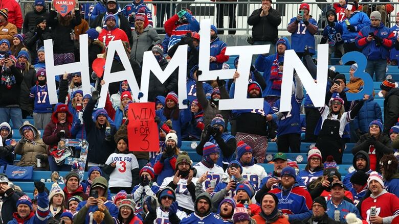 Bills fans in stands in Orchard Park, N.Y., each hold a letter to spell the word 'Hamlin.'