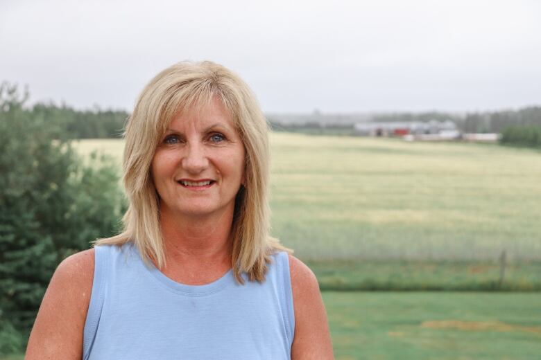 June Ellis standing outside in a field.