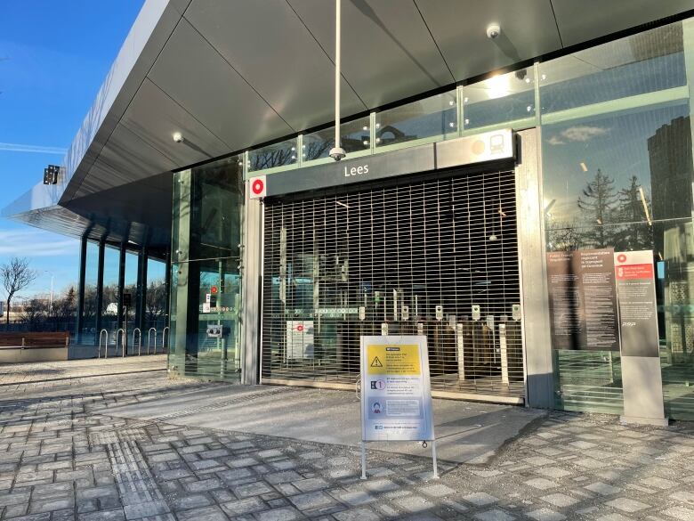 A shuttered light rail station with a sign out in front.