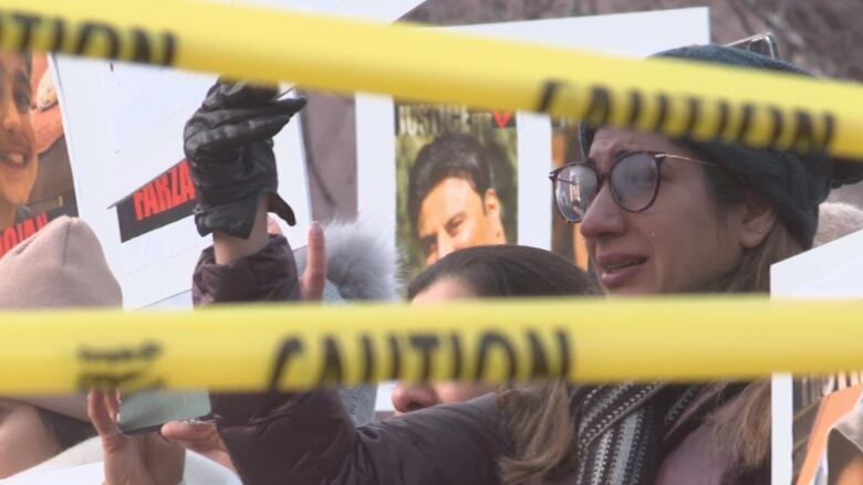 A protestor at the rally outside of city hall crying.