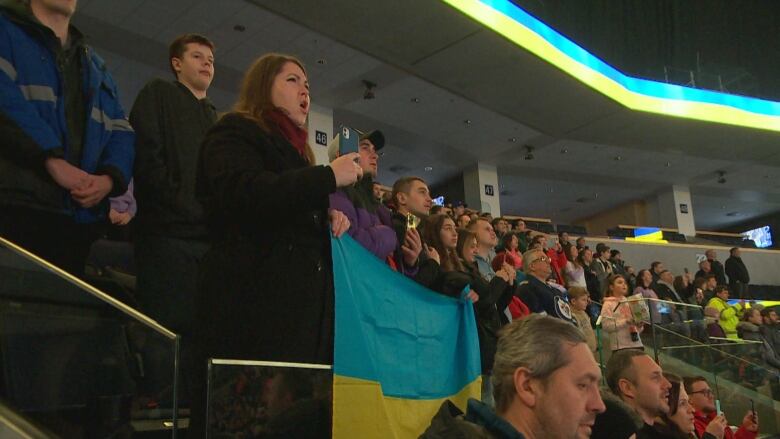 Fans in the stands ahead of a hockey game at Canada Life Centre.