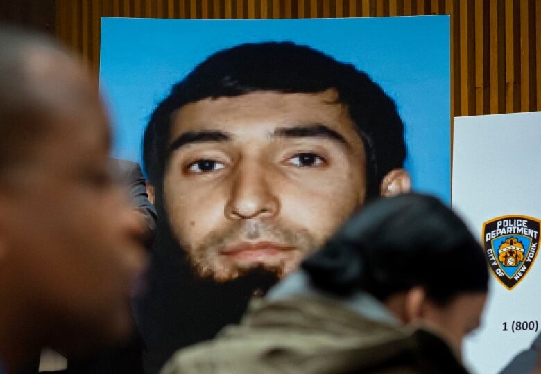 A blown-up picture of a man is displayed in a courtroom.