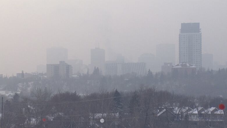 A foggy, far off view of buildings