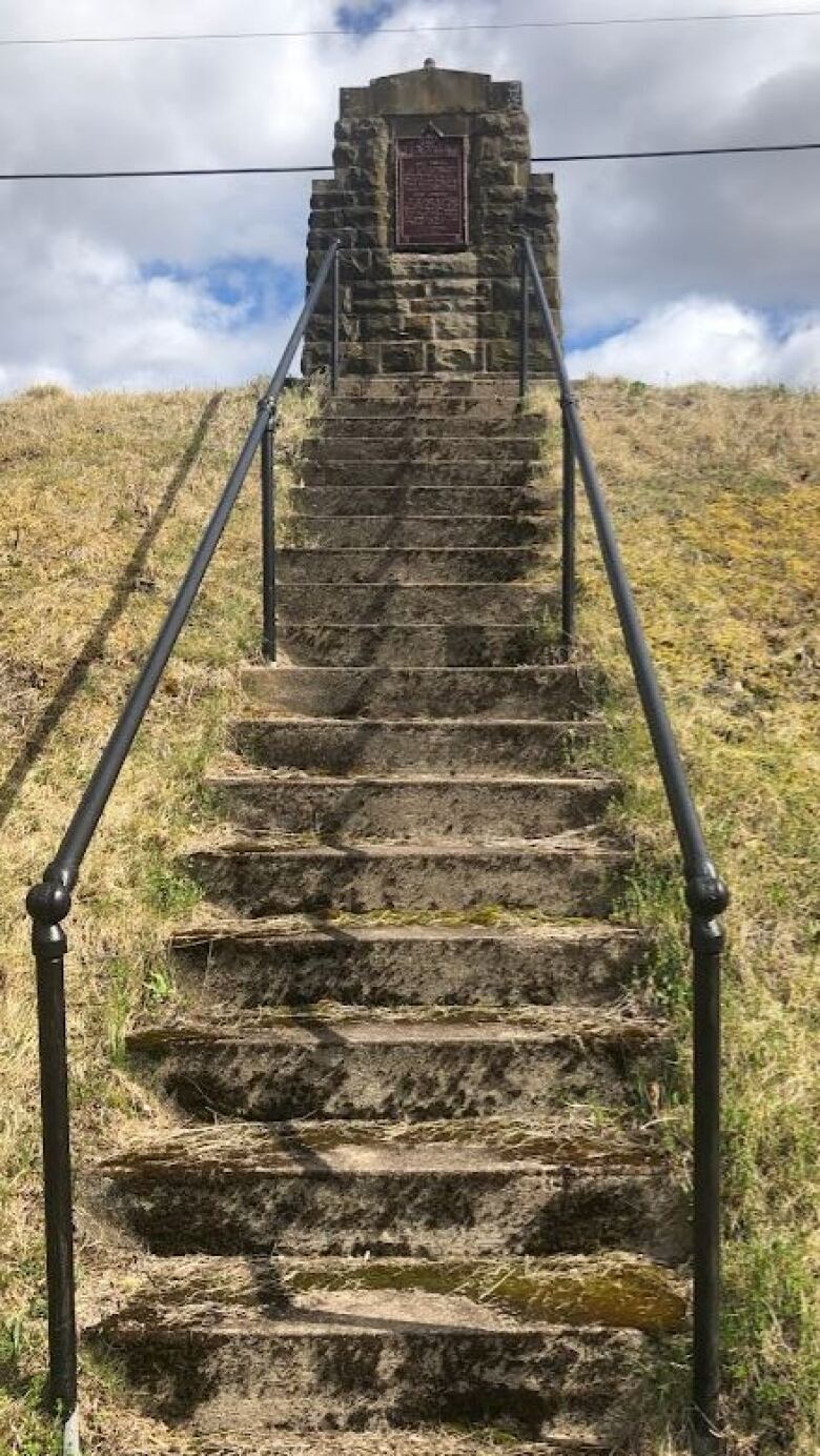 stone stairway covered in moss leading up to a monument