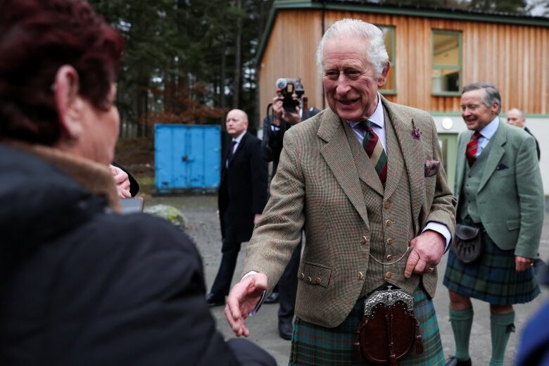 A man reaches out to shake hands.