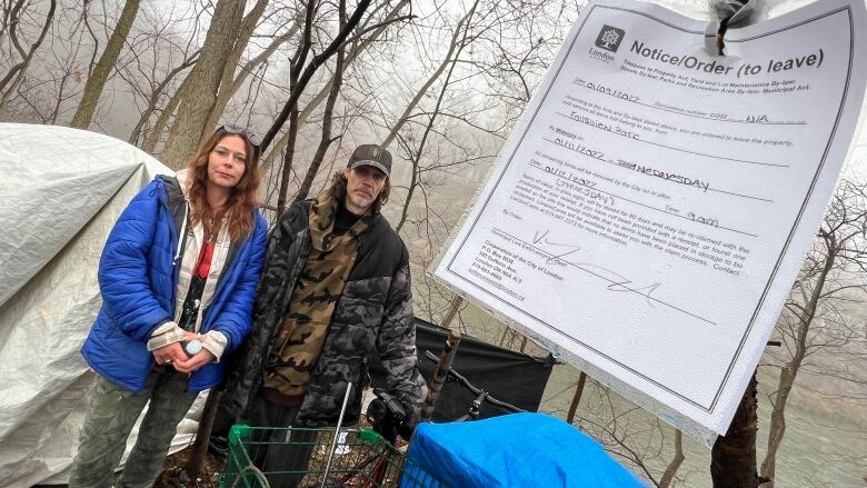 Ronald Parker, shown here with his sister Jennifer, at the riverside spot near the Hydro One parking lot where he's been camping for the past few weeks. The city has issued eviction orders, which could force him to move. 