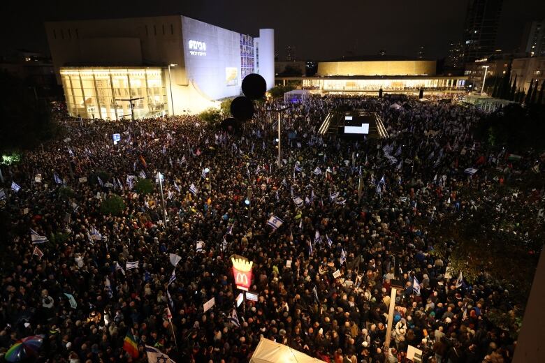 Israeli protesters are seen in Tel Aviv, gathered to protest changes to the legal system that the government wants to make.