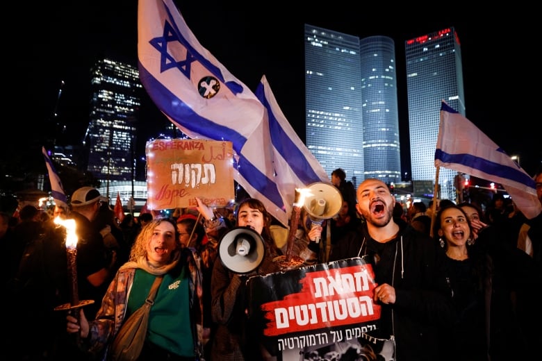 A group of protesters in seen in Tel Aviv on Saturday, at a larger gathering of people showing opposition to proposed judicial reforms.