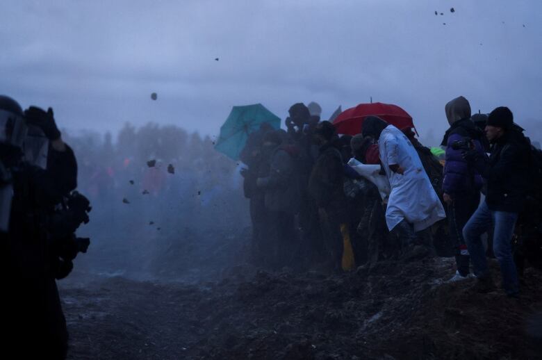 Protesters are hit with water cannons.