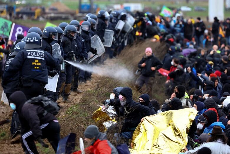 Police clash with protesters.