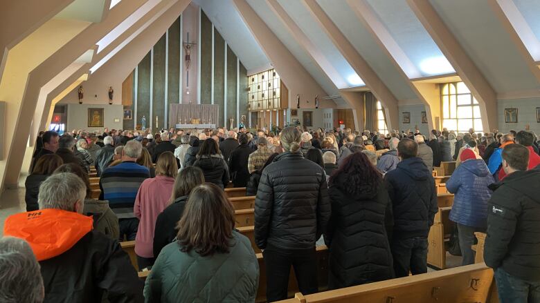 A group of people face an altar.