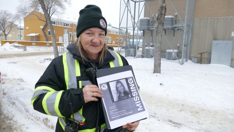 Angela Klassen, co-ordinator with Bear Clan Patrol, holds up a missing persons sign of Gabriel Marsden, who she says has been missing for about one month.