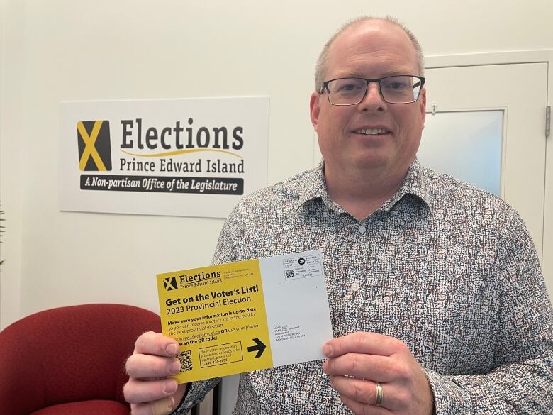 Tim Garrity, P.E.I.'s chief electoral officer, shows the card that will be mailed to P.E.I. household in the coming days.