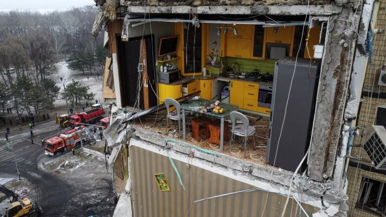 A Dnipro apartment kitchen is exposed to the outdoors after the building was heavily damaged by a Russian missile strike. 