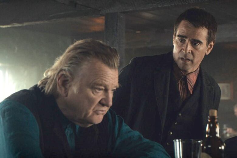 Brendan Gleeson and Colin Farrell are sitting at a bar in a scene from the film The Banshees of Inisherin.