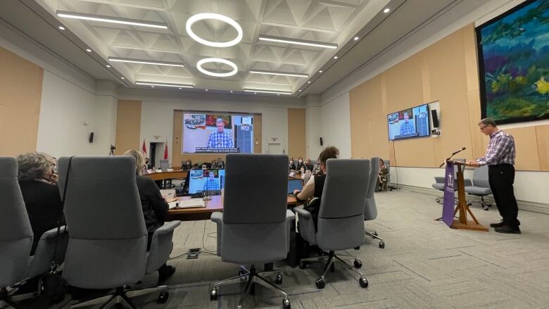 man addressing room